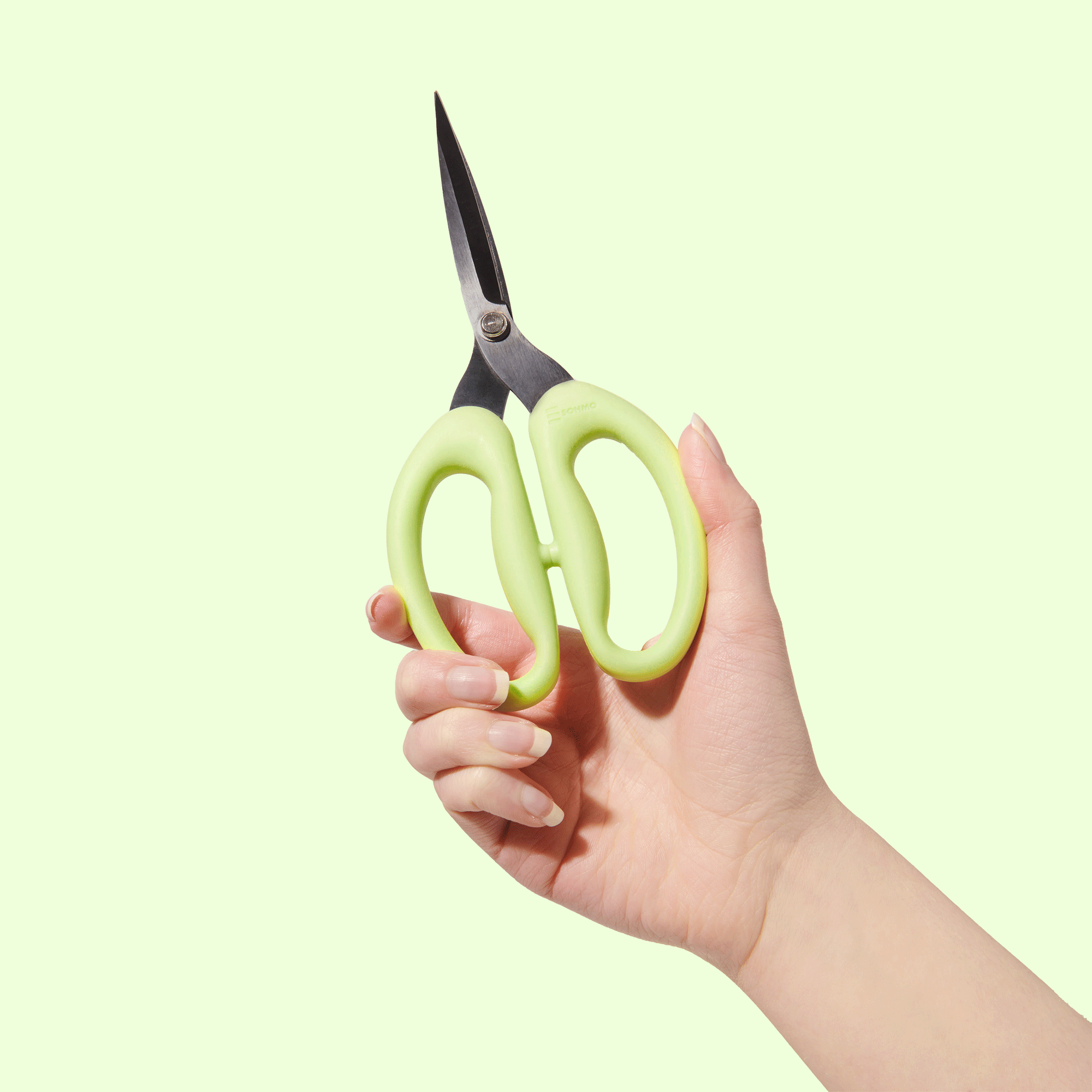 A large pair of SOHMO Go-To Scissors with flexible green handles