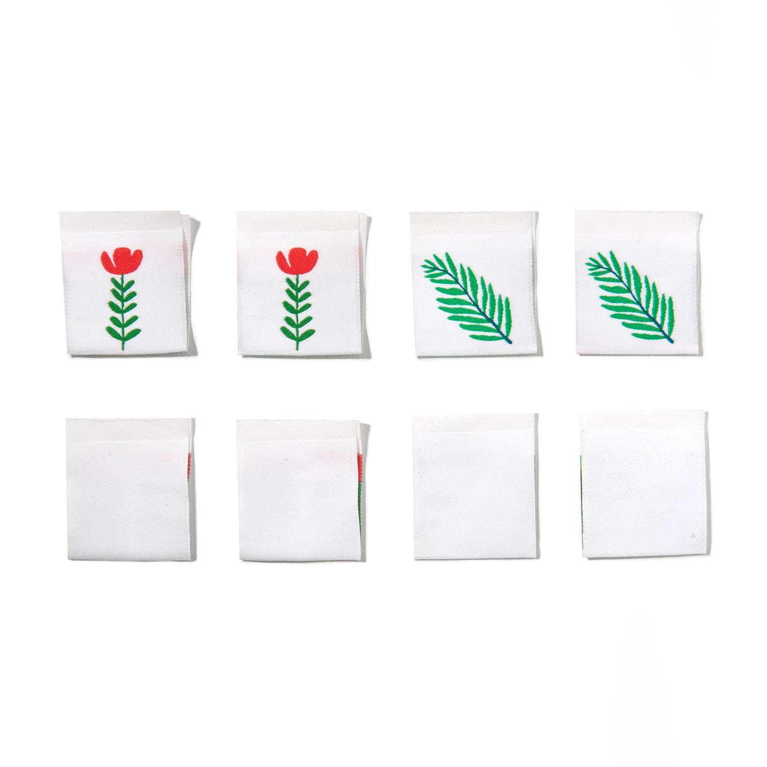 Set of white clothing labels with floral and leaf designs on a white background