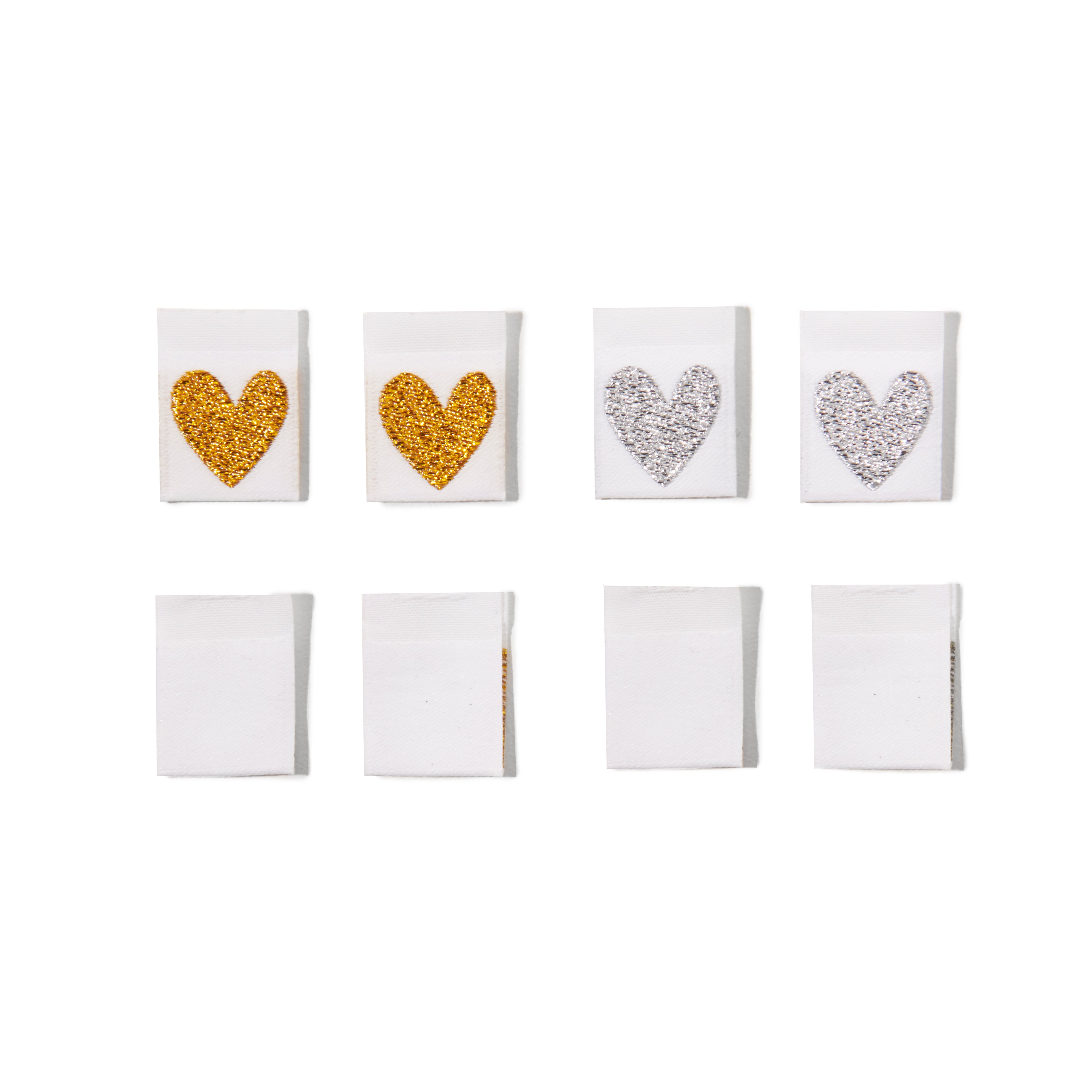 Set of eight white clothing labels with gold, silver, and rhinestone heart designs on a white background.