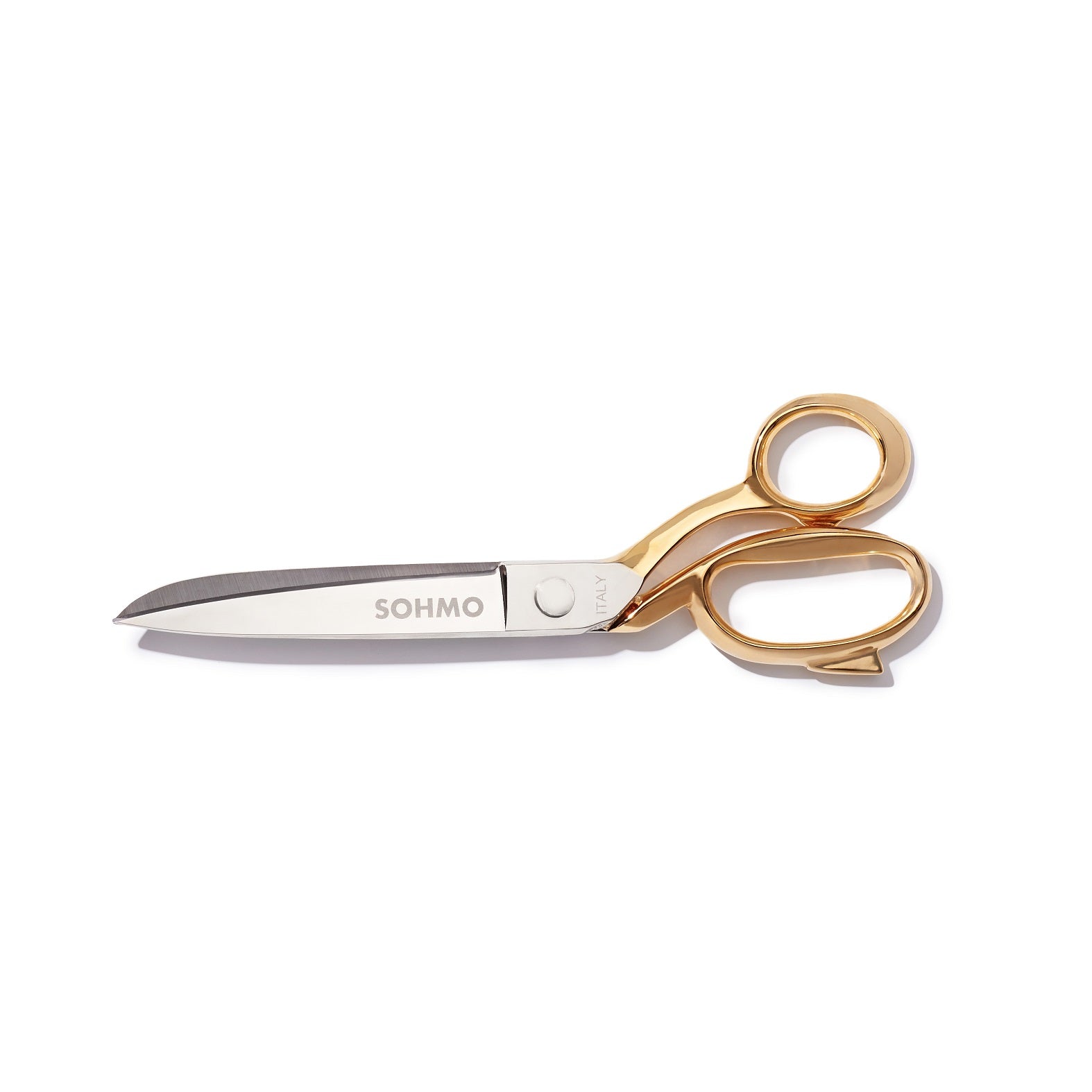 A large pair of fabric scissors with gold handles